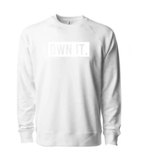 White sweatshirt with the bold slogan 'OWN IT.' on the front.